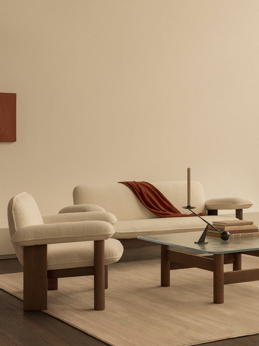 Brasilia Lounge Chair and Sofa in cream bouclé with a Brasilia Lounge Table and Interconnect candle holder.