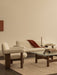Brasilia Lounge Chair and Sofa in cream bouclé with a Brasilia Lounge Table and Interconnect candle holder.