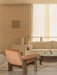 Beige living room with a rust velvet Brasilia Lounge Chair, Offset Sofa, glass Lounge Table, and Interconnect Candle Holder.