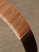 Close-up detail of the Carrie Table Lamp's handle, showing the light brown leather wrapping around the bronzed brass frame.