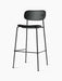 A fully upholstered Co Bar Chair in black with a slender black steel frame, viewed from an angle against a white background.