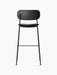Rear view of the Co Bar Chair, fully upholstered in black Dakar leather with a slender, black powder-coated steel frame.