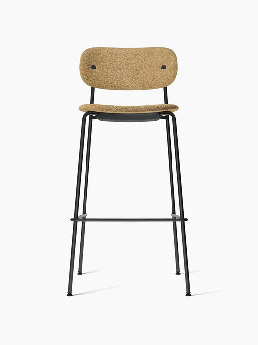 Front view of the Co Bar Chair, Fully Upholstered. It has a black steel frame and light brown Audo Bouclé 06 upholstery.