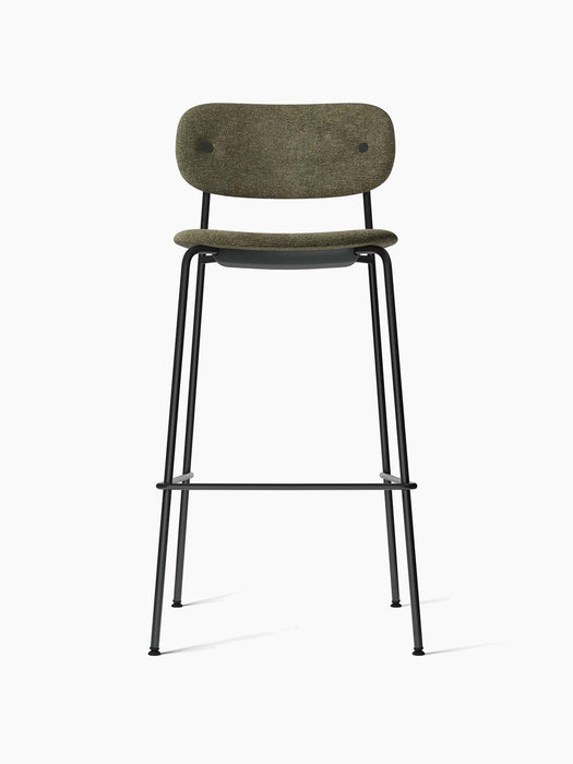 Front view of the Co Bar Chair, fully upholstered in moss green fabric with a slender black powder-coated steel frame.