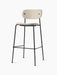 The Co Bar Chair, Fully Upholstered, has a light-coloured textured fabric seat and backrest, on a slender black steel frame.