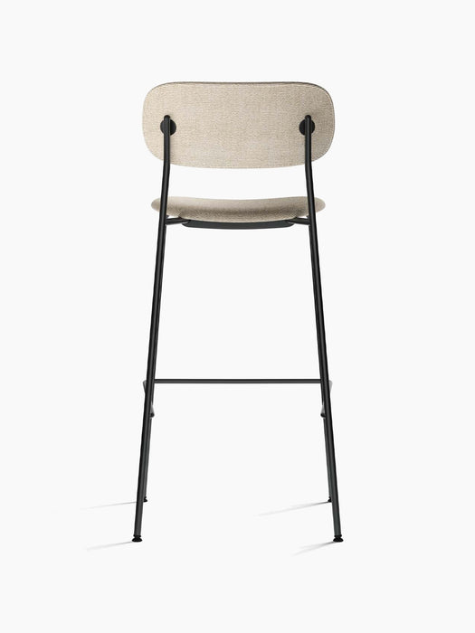 Rear view of the Co Bar Chair, Fully Upholstered, with light beige fabric seat and back on a slender black steel frame.