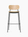 Front view of the Co Bar Chair with a natural oak backrest, a beige bouclé upholstered seat, and a slender black steel frame.