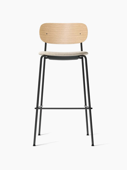 Front view of the Co Bar Chair, Seat Upholstered, with a natural oak backrest, moss fabric seat, and black steel frame.