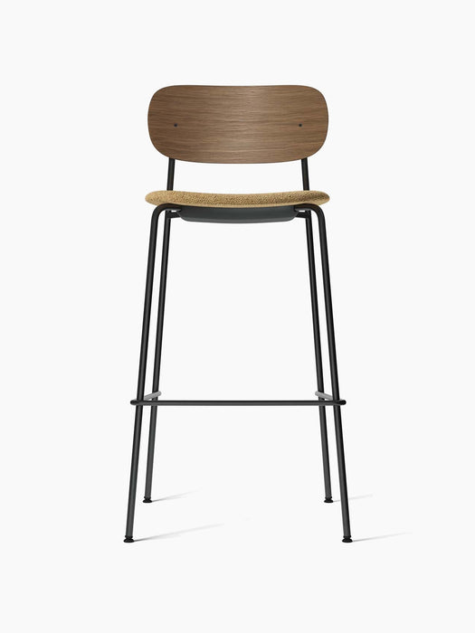 Front view of the Co Bar Chair with a dark stained oak backrest, beige bouclé upholstered seat, and slender black frame.