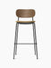 Front view of the Co Bar Chair with a dark stained oak backrest, beige bouclé upholstered seat, and slender black frame.