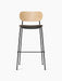 Front view of the Co Bar Chair, Seat Upholstered, with a natural oak backrest, dark fabric seat, and black steel frame.
