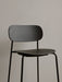 A close-up of the Co Bar Chair in black oak veneer, showing the detail of the wood grain on the backrest and seat.