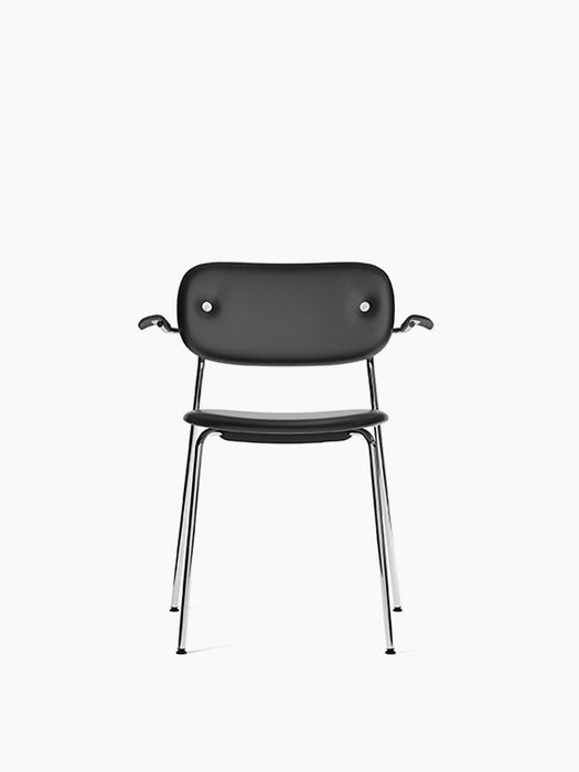 Front view of the Co Dining Chair, fully upholstered in black leather with black oak armrests and sleek, shiny chrome frame.