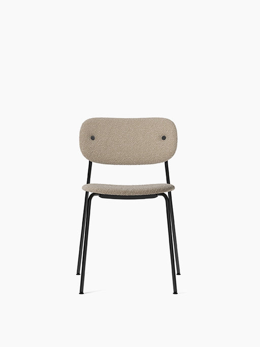 Front view of the Co Dining Chair, fully upholstered in Lupo Sand fabric, with a slim black powder-coated steel frame.