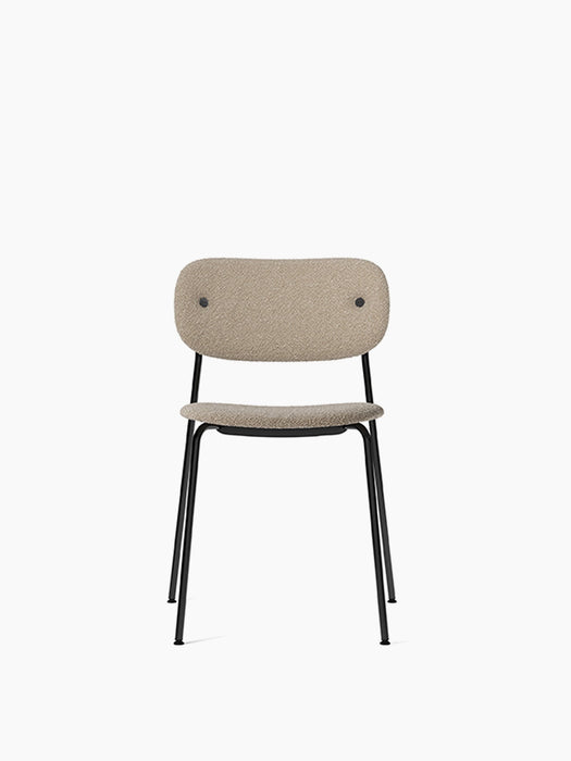 Front view of the Co Dining Chair, fully upholstered in Lupo Sand fabric, with a slim black powder-coated steel frame.
