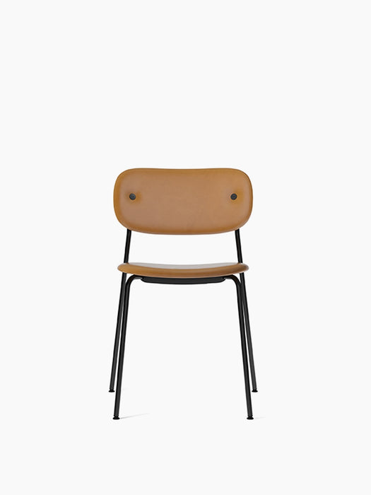Front view of the Co Dining Chair, fully upholstered in tan Dakar leather with a slender black powder-coated steel frame.