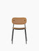Front view of the Co Dining Chair, fully upholstered in tan Dakar leather with a slender black powder-coated steel frame.