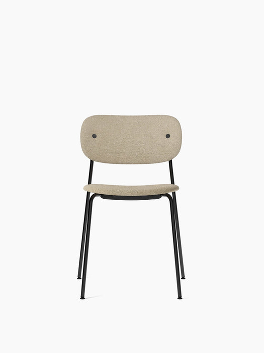 Front view of the Co Dining Chair, fully upholstered in a beige bouclé fabric with a slender black steel frame.