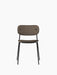 A front view of the Co Dining Chair, featuring a fully upholstered brown seat and backrest on a slim, black steel frame.