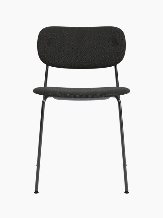 A front view of the Co Dining Chair, fully upholstered in black fabric with a slim, black powder-coated steel frame.
