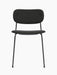 A front view of the Co Dining Chair, fully upholstered in black fabric with a slim, black powder-coated steel frame.