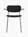 Front view of the black, fully upholstered Co Dining Chair with dark wood armrests and a slender black steel frame.
