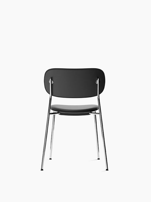 Rear view of Co Dining Chair, fully upholstered in black with a slender, polished chrome frame, against a white background.