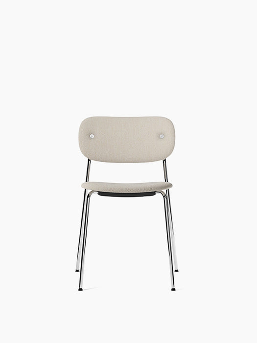 Front view of the Co Dining Chair, fully upholstered in a light beige textured fabric with a slender, polished chrome frame.