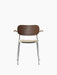 Front view of the Co Dining Chair with armrests, showing its dark stained oak backrest, beige bouclé seat, and chrome frame.
