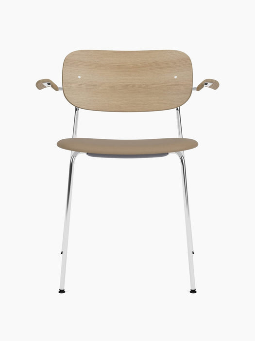 Front view of the Co Dining Chair with armrests, featuring a natural oak back, beige upholstered seat and chrome frame.