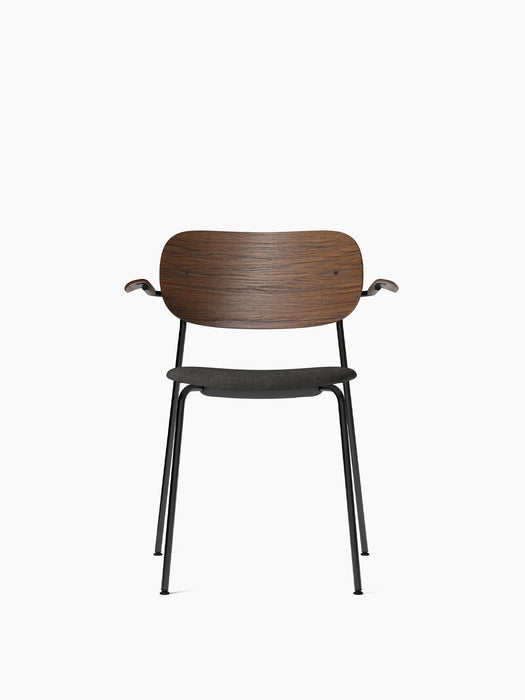 Front view of the Co Dining Chair with armrests, dark stained oak back, dark grey upholstered seat, and black frame.