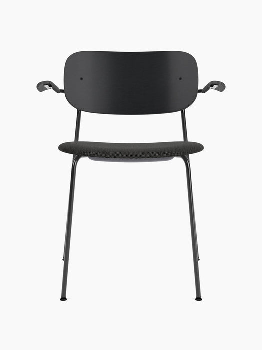 A front-facing image of the Co Dining Chair with a black frame, armrests, a wide black backrest, and a dark grey fabric seat.