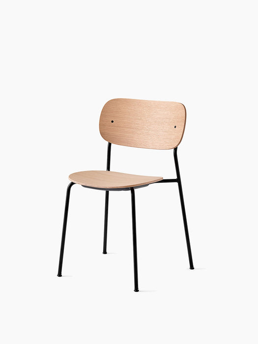 Co Dining Chair in Natural Oak with a black steel frame, shown at an angle on a white background.
