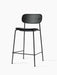 The Co Counter Chair, fully upholstered in black Dakar leather with a slender black steel frame, viewed from an angle.