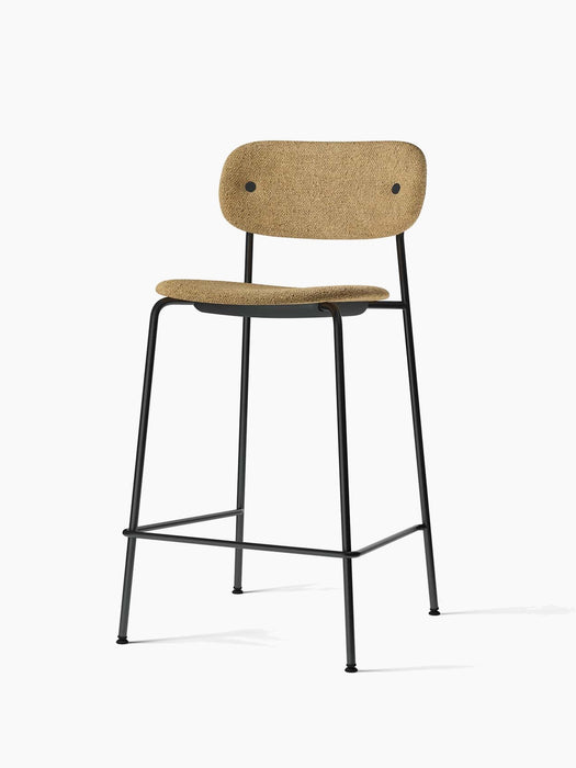 Angled view of the Co Counter Chair, upholstered in textured light brown bouclé with a slender black steel frame.