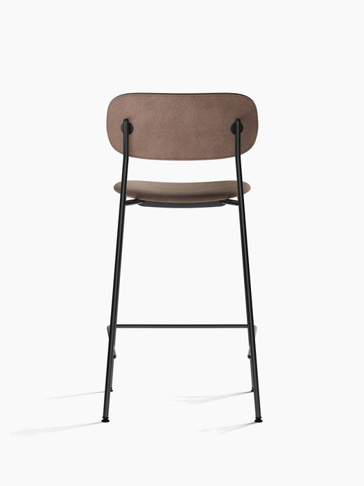 Back view of Co Counter Chair, Fully Upholstered, showing its light brown fabric seat and backrest on a black steel frame