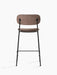 Back view of Co Counter Chair, Fully Upholstered, showing its light brown fabric seat and backrest on a black steel frame
