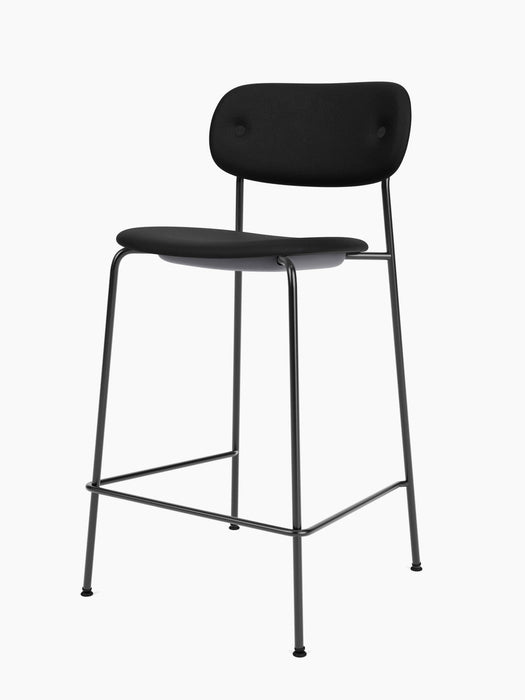 A fully upholstered Co Counter Chair in black fabric with a black powder-coated steel frame, shown at an angle.