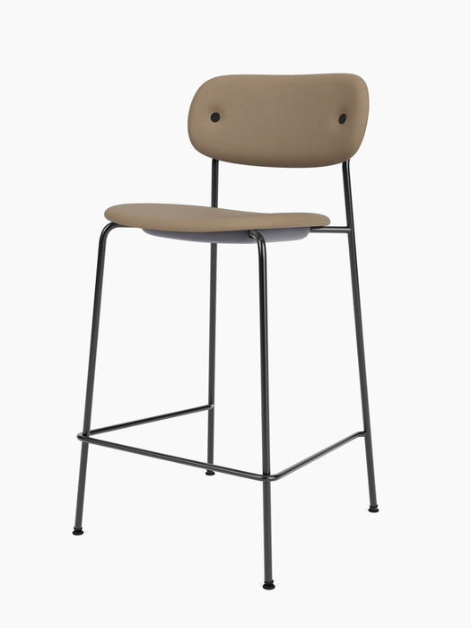 Angled view of the Co Counter Chair, Fully Upholstered, with light brown seat and back on a slender black frame.