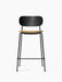 A Co Counter Chair with a black steel frame, a curved black oak backrest, and a seat upholstered in beige bouclé fabric.
