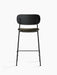 Rear view of the Co Counter Chair with a black oak backrest, moss-coloured upholstered seat, and a slender black steel frame.