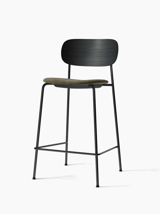 Co Counter Chair, Seat Upholstered. Black steel frame, black oak backrest, and moss green upholstered seat. Angled view.