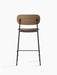 Back view of the Co Counter Chair with a dark stained oak backrest, upholstered seat, and slender black steel frame.
