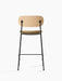 Back view of the Co Counter Chair, Seat Upholstered, showing its natural oak backrest, beige bouclé seat, and black legs.