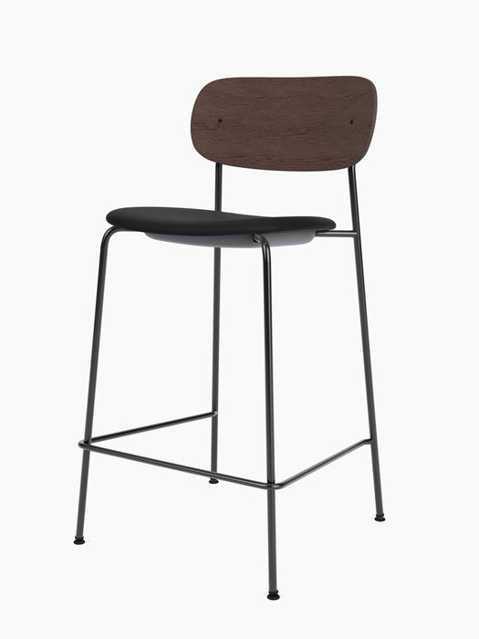 Angle view of the Co Counter Chair, Seat Upholstered, with a dark stained oak backrest, black seat, and slender black frame.