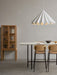 Minimalist dining room with two oak Co Counter Chairs at a Snaregade Table, a Dancing Pendant above and a Curiosity Cabinet.