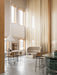 A bright room with a Tearoom Sofa, Plinth table, Snaregade table with Co Counter Chairs under a Dancing Pendant light.