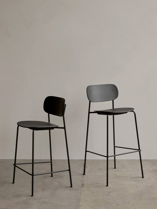 Side-by-side comparison of the Co Counter Chair and Co Bar Chair, both in black oak veneer with black steel frames.