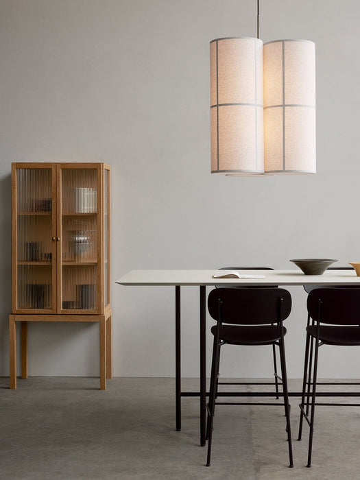 Two Co Counter Chairs at a Snaregade Counter Table with a Curiosity Cabinet and Hashira Pendant Cluster in a minimalist room.