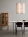 Two Co Counter Chairs at a Snaregade Counter Table with a Curiosity Cabinet and Hashira Pendant Cluster in a minimalist room.